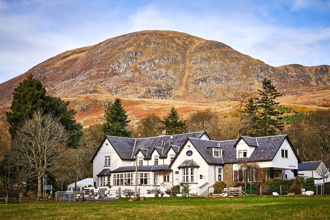 Exterior view of Glen Clova Hotel with glens in the background